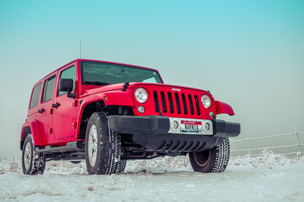 Red Jeep on Snow Covered Road