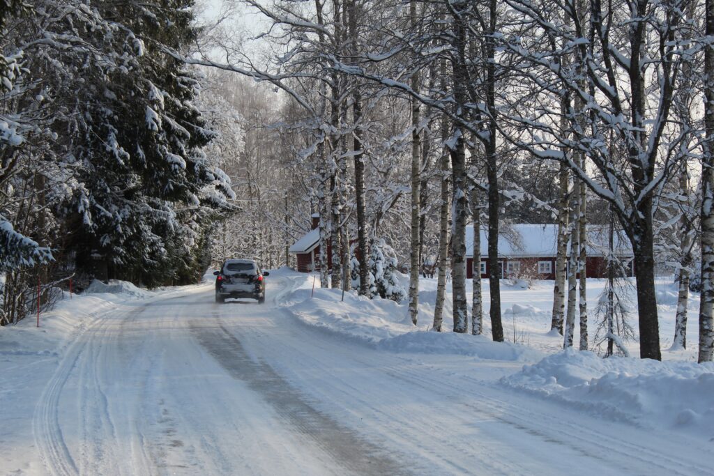 Car driving on a snowy road for Christmas travel